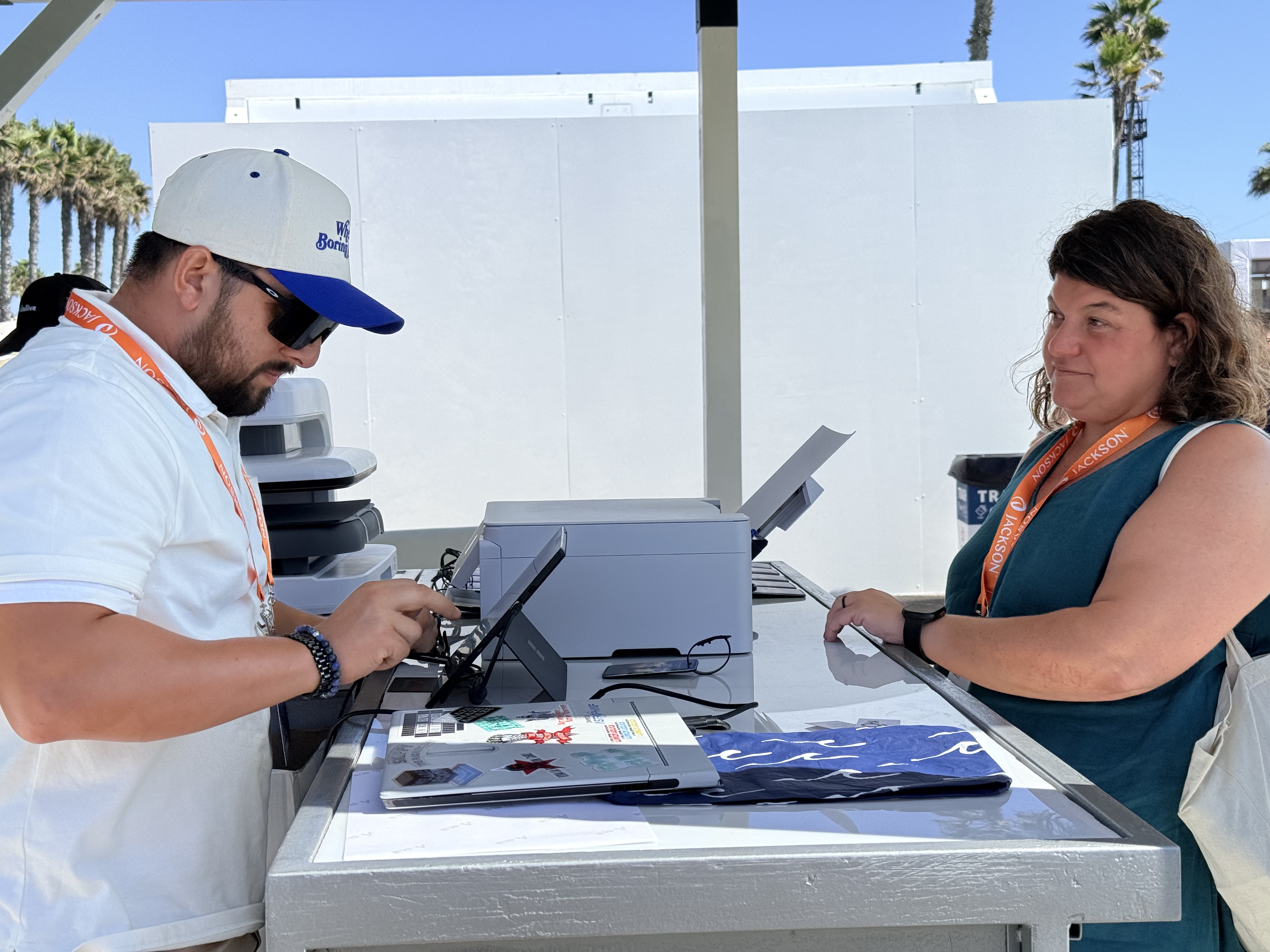 A Threaded Live technician setting up a guest's monogram at the station while she waits